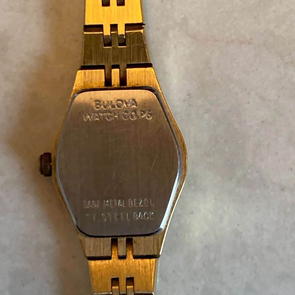 Bulova 14 k Gold filled, Quartz with Black face and small Diamond. France stamp.